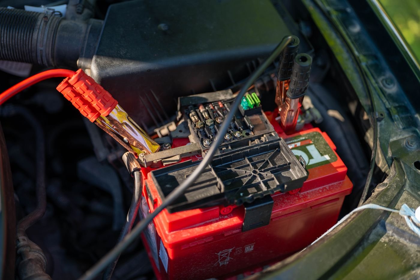 Jumper cables attached to a car battery