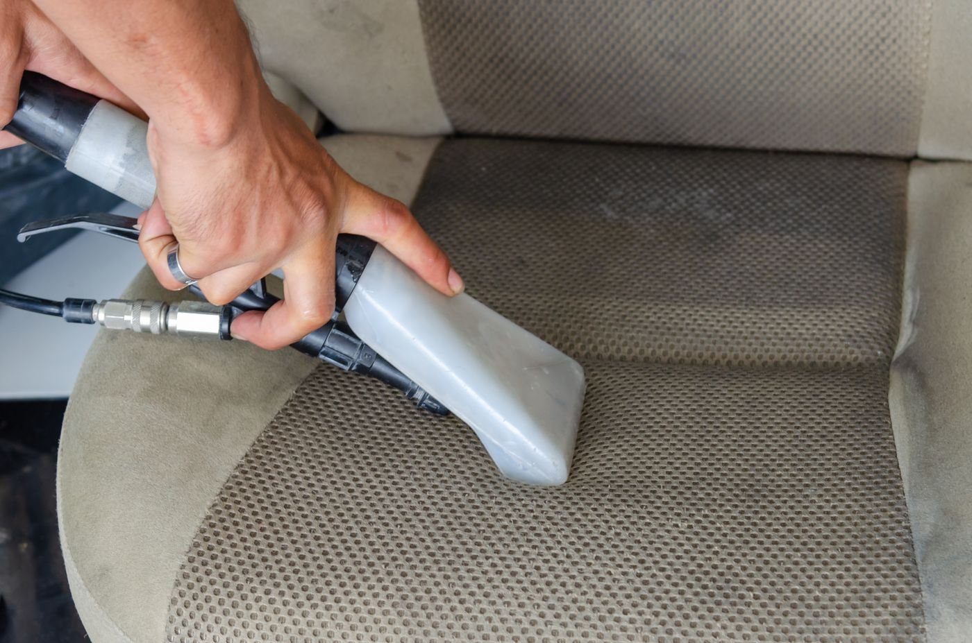 Car seat being deep cleaned with an extractor