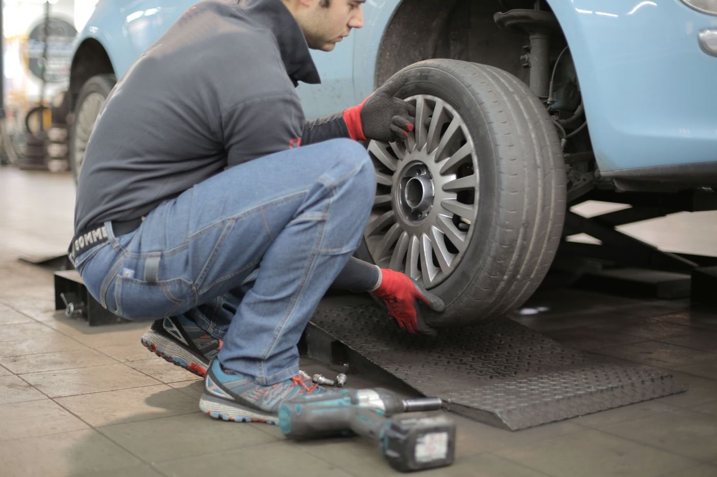 Wheel being removed from a car with an impact wrench