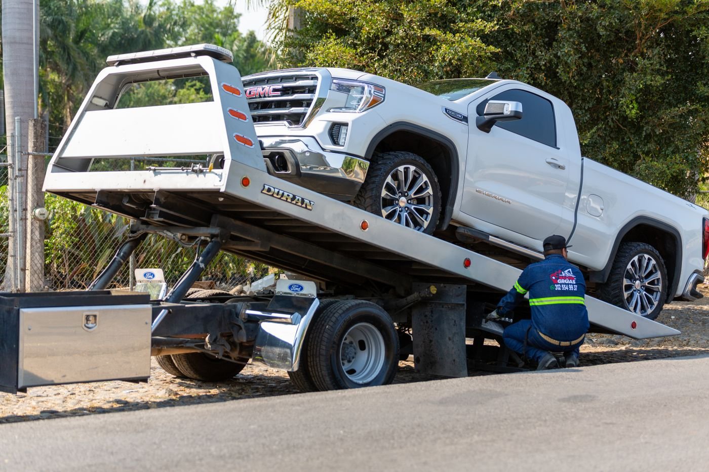 Vehicle being winched onto a recovery truck